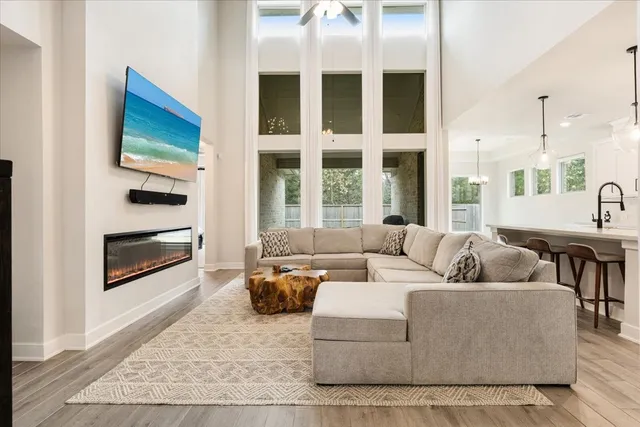 a living room with furniture tv and a fireplace