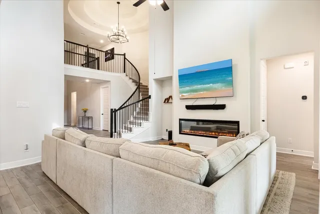 a living room with furniture and a ceiling fan
