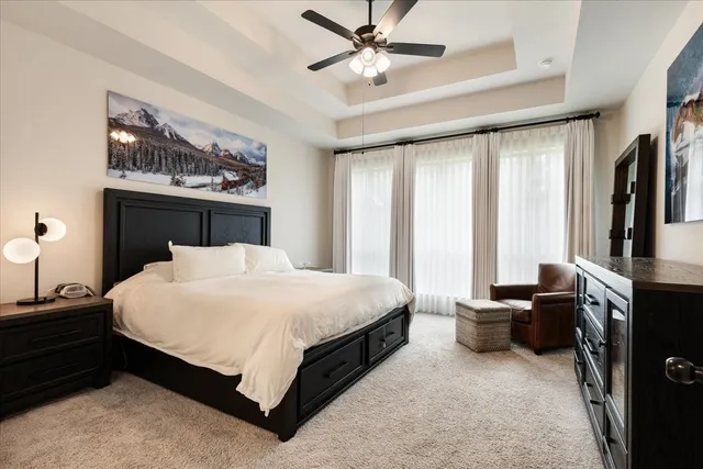 a bedroom with a bed and a chandelier