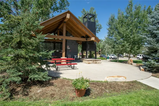 a view of patio with a table and chairs under an umbrella