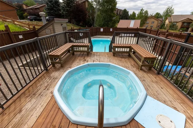 a view of balcony with wooden floor and outdoor seating