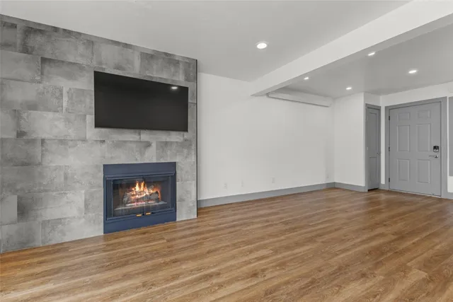 a view of kitchen with stainless steel appliances granite countertop cabinets and wooden floor