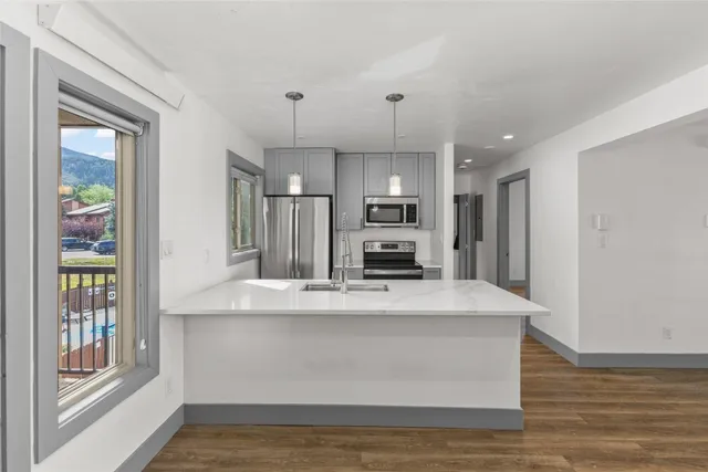 a large kitchen with sink a refrigerator and a stove