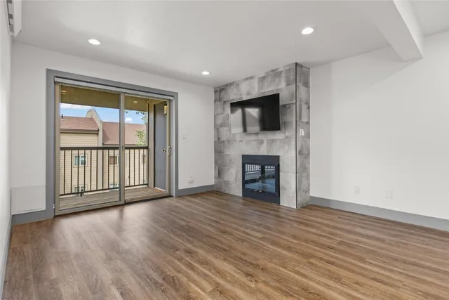 an empty room with wooden floor and a window