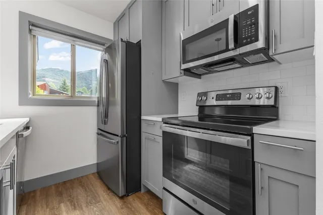 a stove top oven sitting inside of a kitchen
