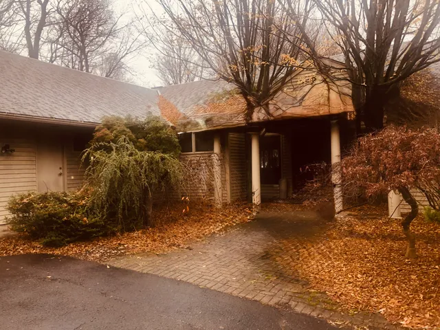 a view of a house with a yard covered with snow