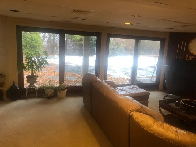 a living room with furniture and large windows