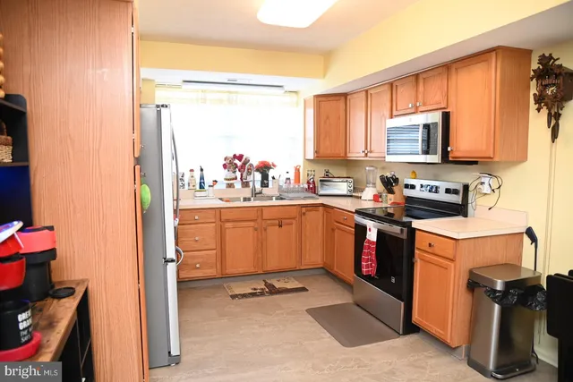 a kitchen with a sink stove and refrigerator