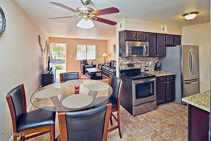 540 South West Road, Unit 29 Wickenburg, AZ 85390 - Photo 4 of 9 a kitchen with a dining table and chairs