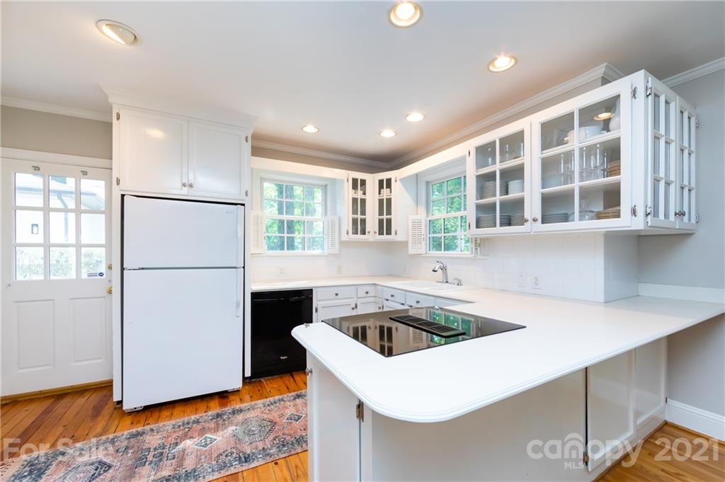 816 Sedgefield Road Charlotte, NC 28209 - Photo 12 of 29 a kitchen that has a sink a refrigerator and cabinets