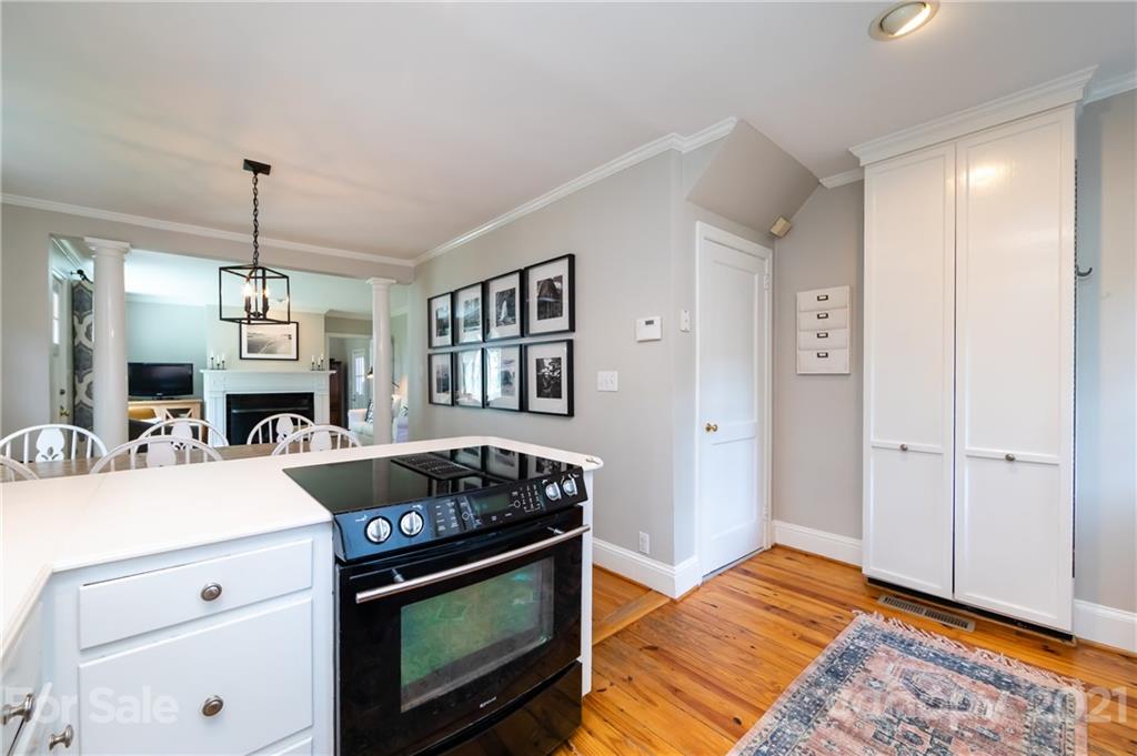 816 Sedgefield Road Charlotte, NC 28209 - Photo 13 of 29 a kitchen with a stove and a wooden floor