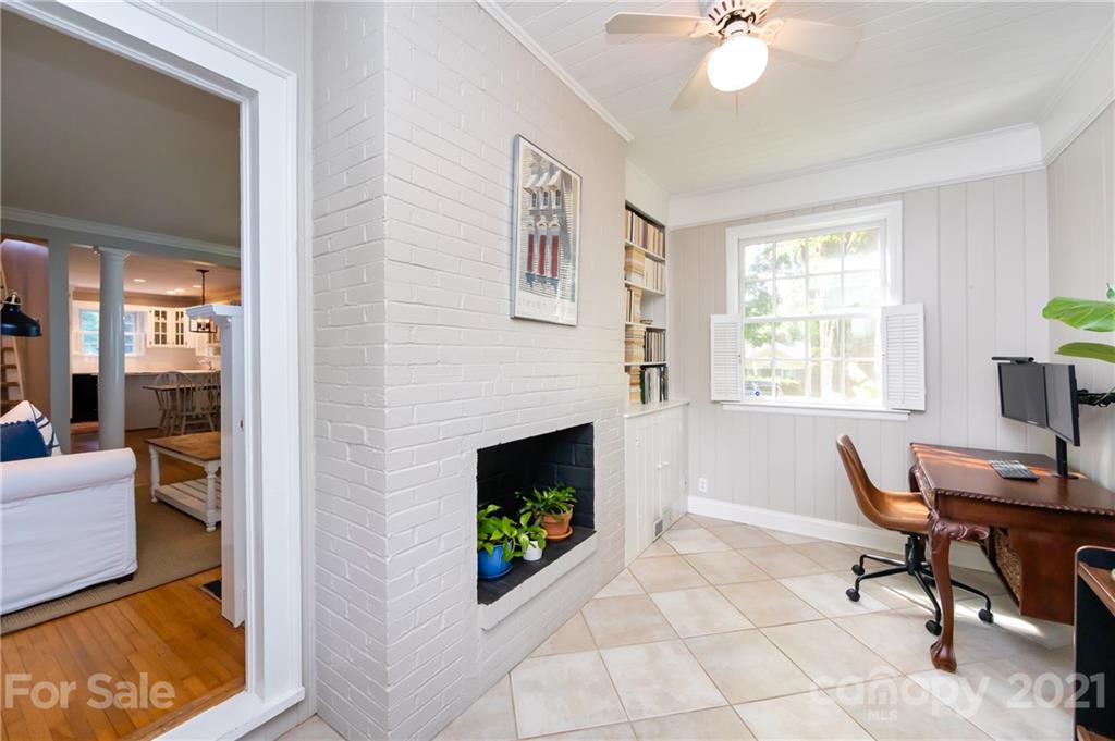 816 Sedgefield Road Charlotte, NC 28209 - Photo 14 of 29 a living room with furniture a dining table and a fireplace