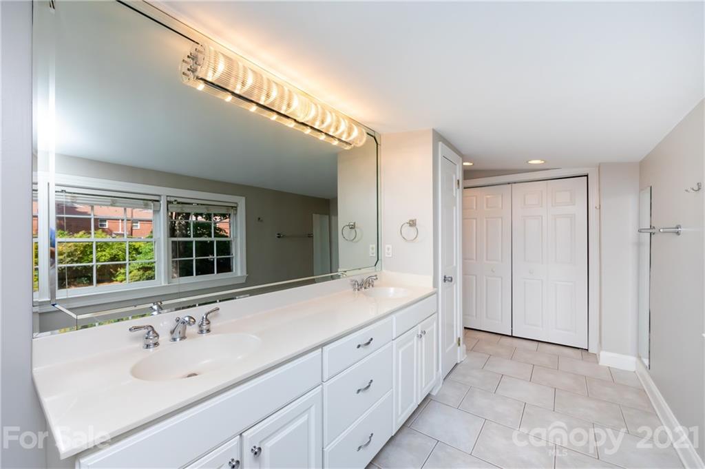 816 Sedgefield Road Charlotte, NC 28209 - Photo 19 of 29 a bathroom with a sink and a large mirror