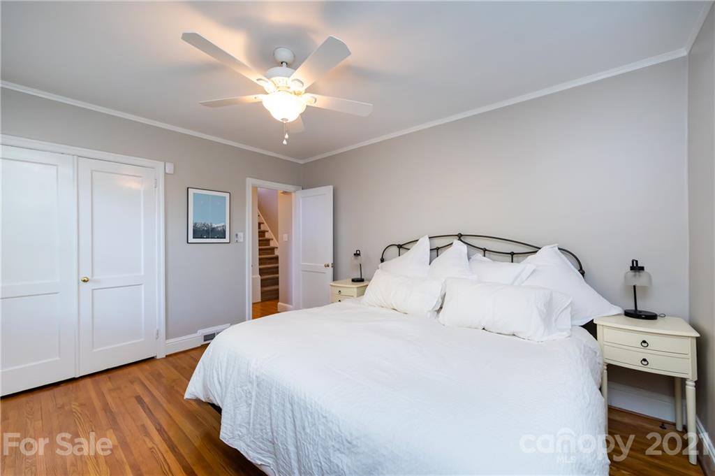 816 Sedgefield Road Charlotte, NC 28209 - Photo 21 of 29 a bedroom with a bed and a chandelier