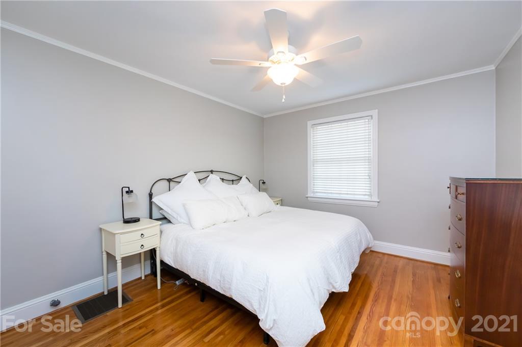 816 Sedgefield Road Charlotte, NC 28209 - Photo 22 of 29 a bedroom with a bed and wooden floor