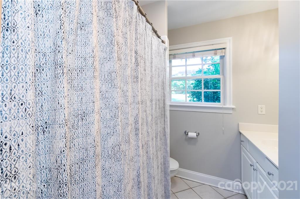 816 Sedgefield Road Charlotte, NC 28209 - Photo 23 of 29 a bathroom with a shower curtain