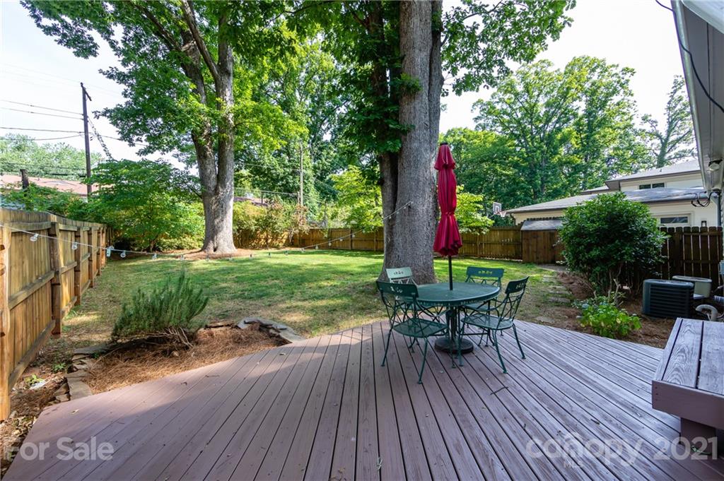 816 Sedgefield Road Charlotte, NC 28209 - Photo 29 of 29 a view of a table and chairs on the deck in front of statue