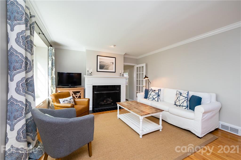 816 Sedgefield Road Charlotte, NC 28209 - Photo 5 of 29 a living room with furniture a flat screen tv and a fireplace