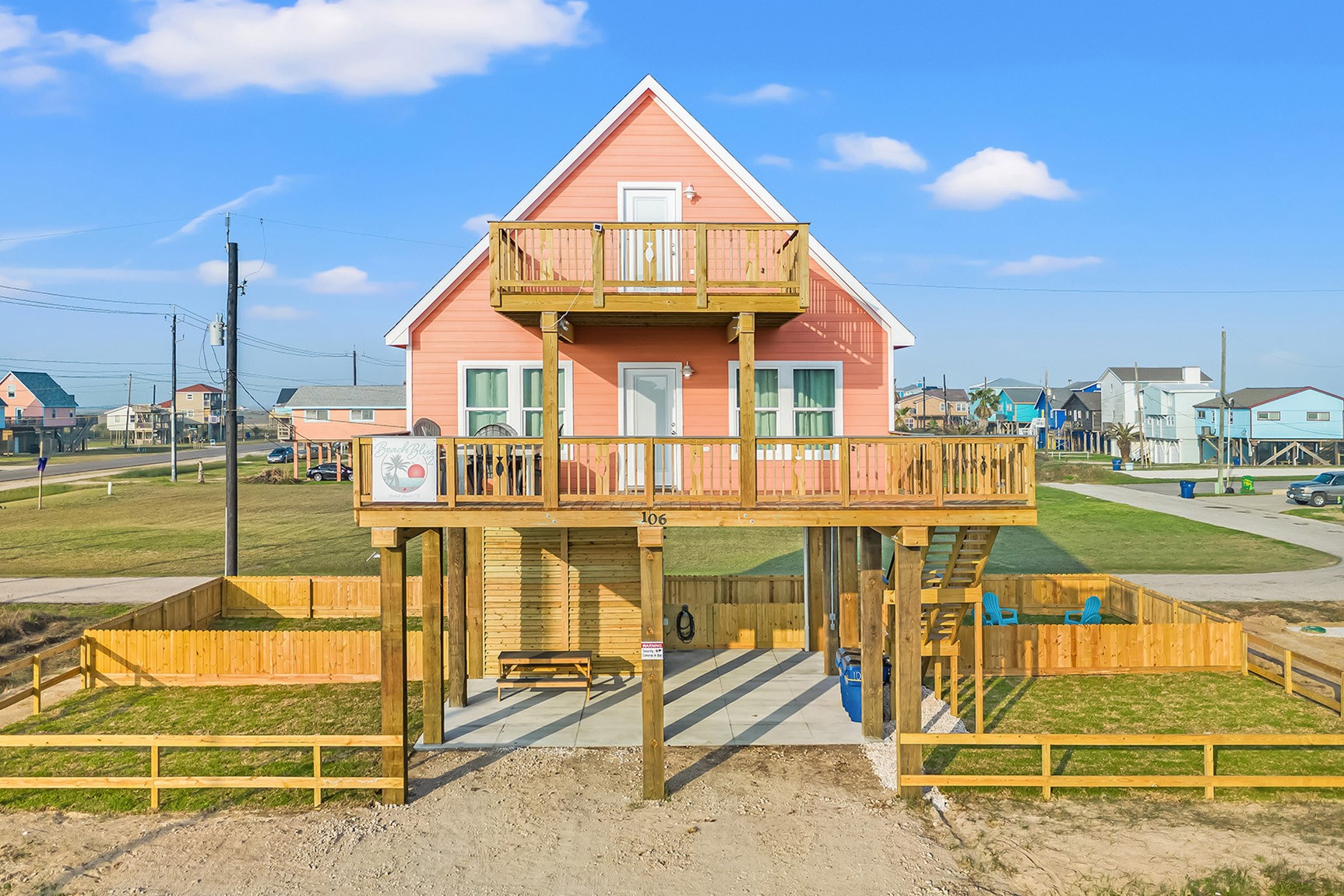 a view of a swimming pool with a bench and lawn chairs
