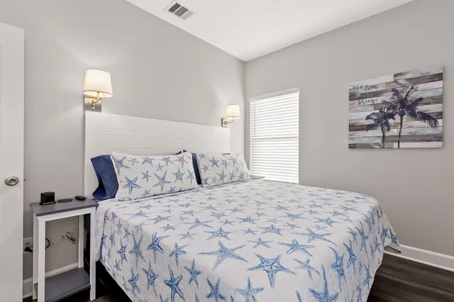 a bedroom with a bed and a night stand