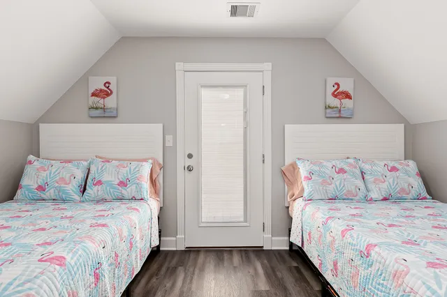 a bedroom with a bed and a painting on the wall