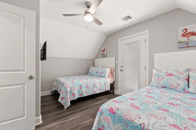 a bedroom with bed and wooden floor