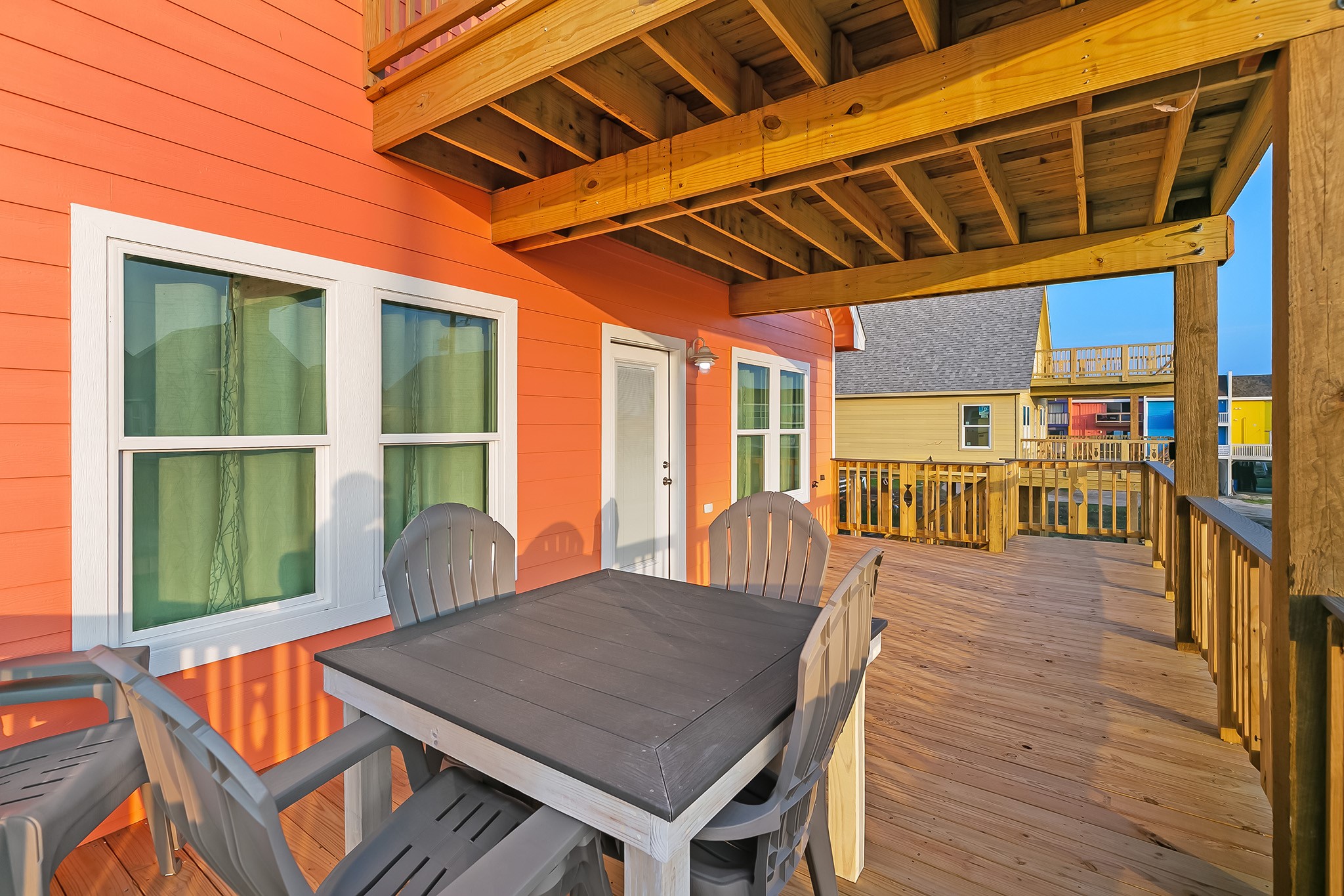 106 Pelican Place Surfside Beach, TX 77541 - Photo 7 of 46 a view of a patio with table and chairs with wooden floor and fence