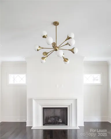 a living room with a fireplace and a ceiling fan
