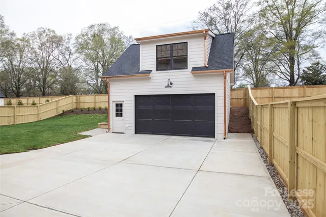 a view of house and garden with a trees