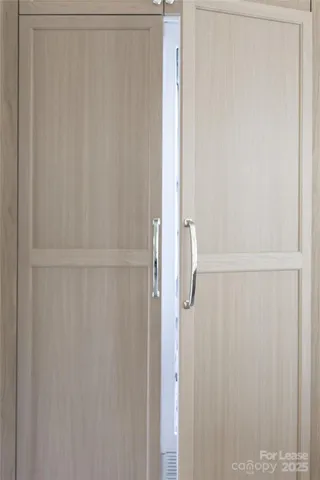 a kitchen with a sink window and cabinets