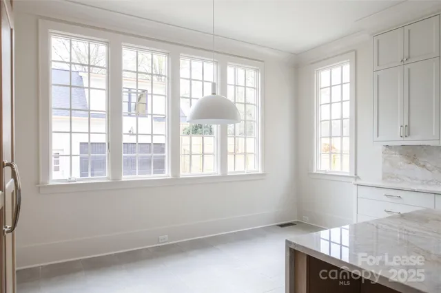 a kitchen with a stove a sink and a window