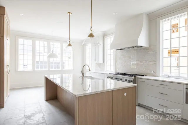 a view of a kitchen with kitchen island a large window