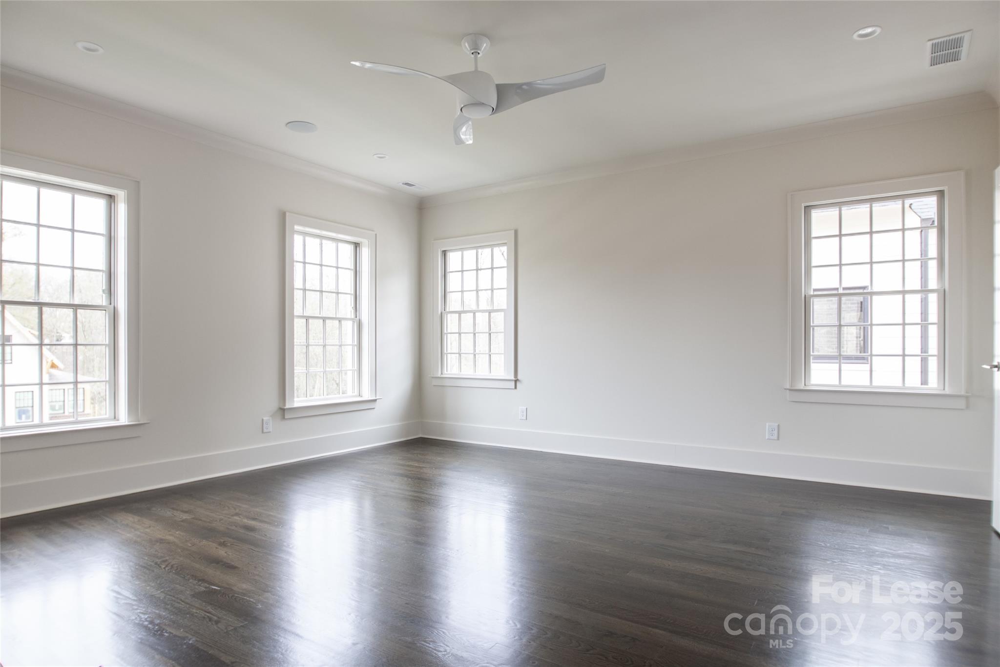 5024 Gilchrist Road Charlotte, NC 28211 - Photo 41 of 48 an empty room with wooden floor and windows