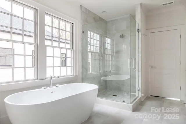 a bathroom with a tub sink and mirror