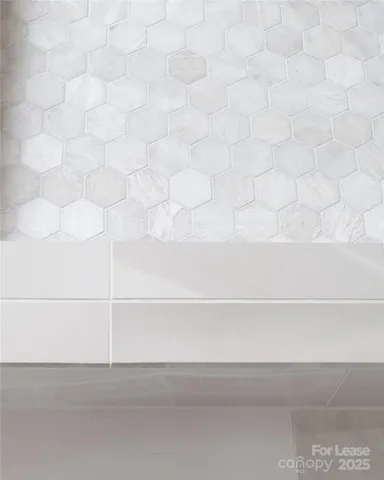 a bathroom with a glass shower door