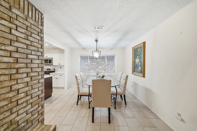 a view of a dining room with furniture and window