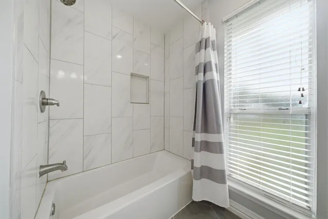 a bathroom with a bathtub and a shower