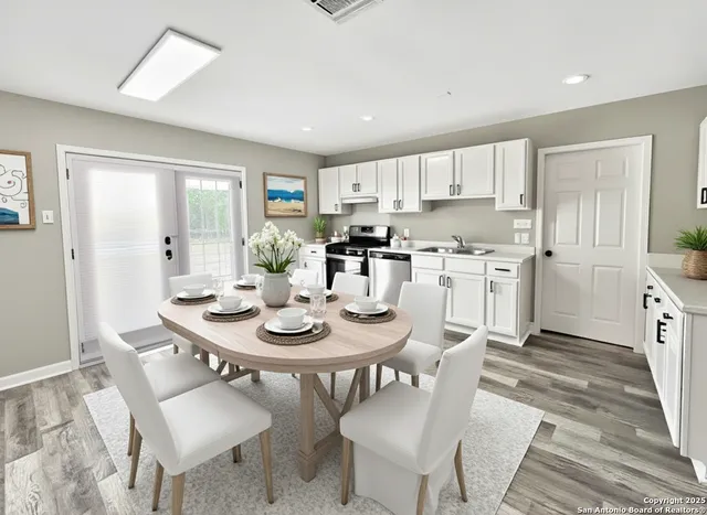 a view of a dining room with furniture and wooden floor