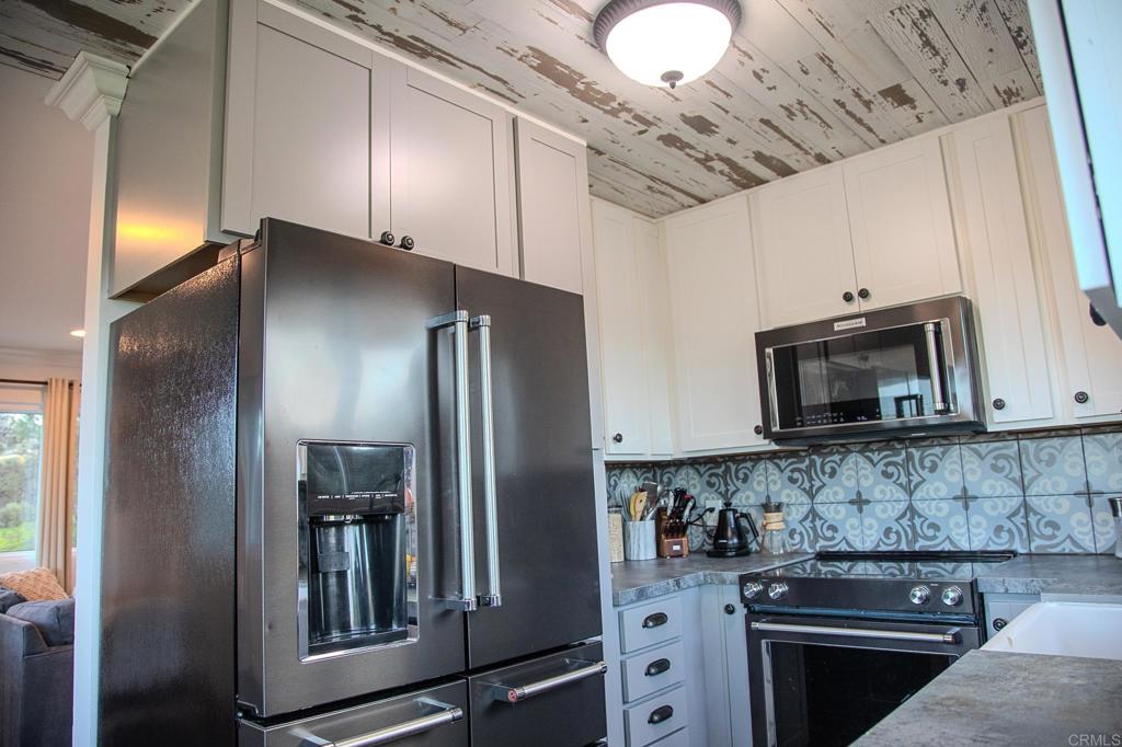 751 South Grade Road Alpine, CA 91901 - Photo 33 of 67 a kitchen with stainless steel appliances granite countertop a stove a refrigerator and a microwave