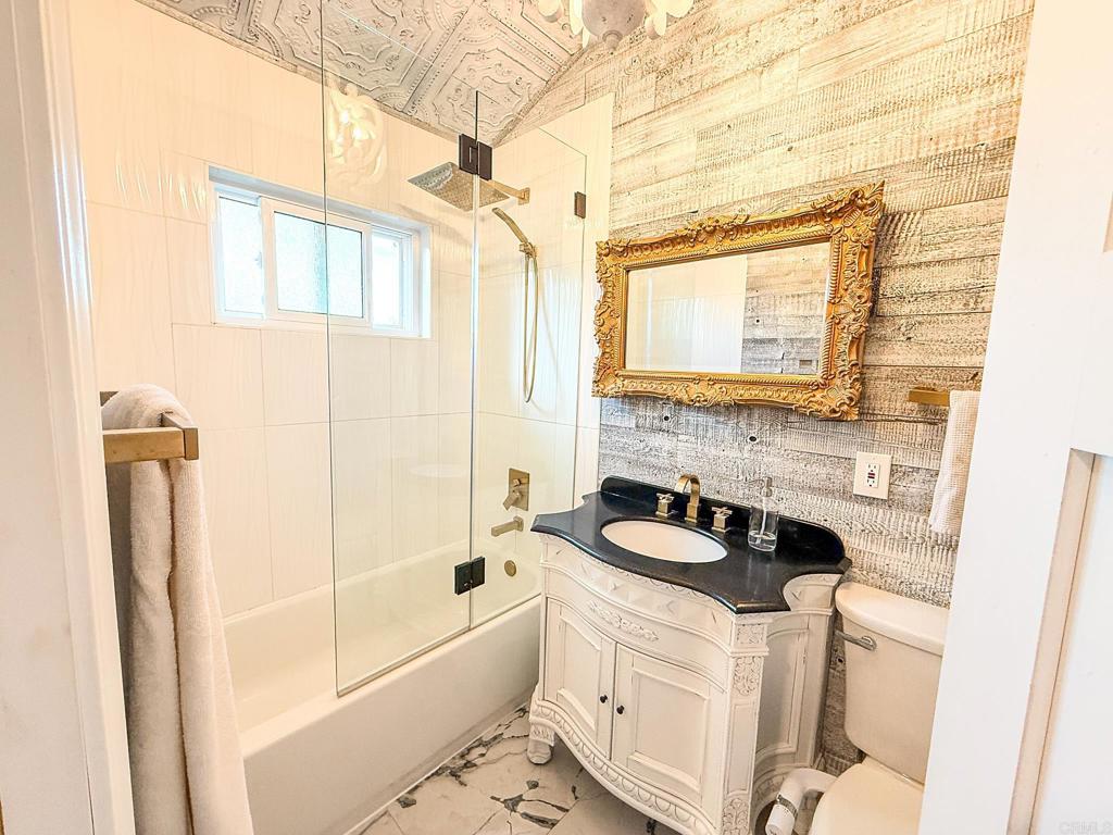 751 South Grade Road Alpine, CA 91901 - Photo 40 of 67 a bathroom with a granite countertop sink a toilet and bathtub
