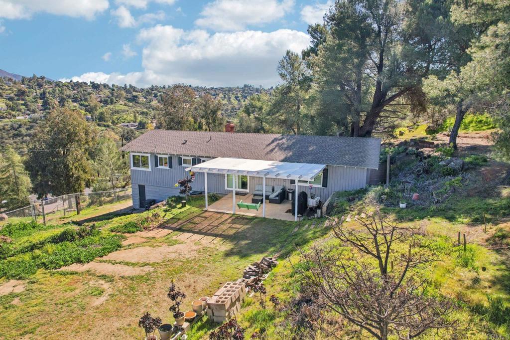 751 South Grade Road Alpine, CA 91901 - Photo 61 of 67 a view of a big house with a big yard and large tree