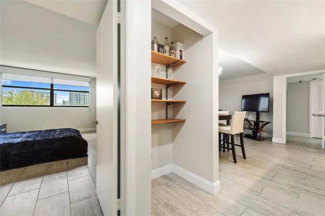 a view of a bedroom with a bed and workspace