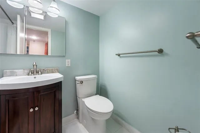 a bathroom with a sink a toilet and mirror