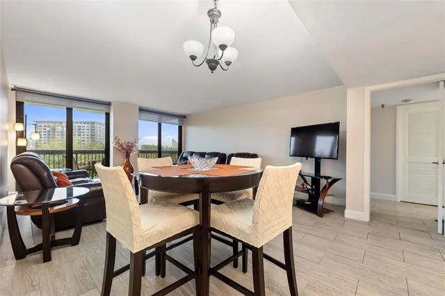 a view of a dining room with furniture and a chandelier