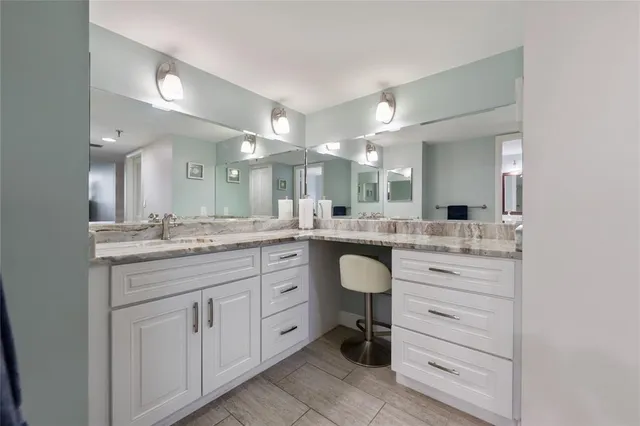 a bathroom with a granite countertop sink mirror and double