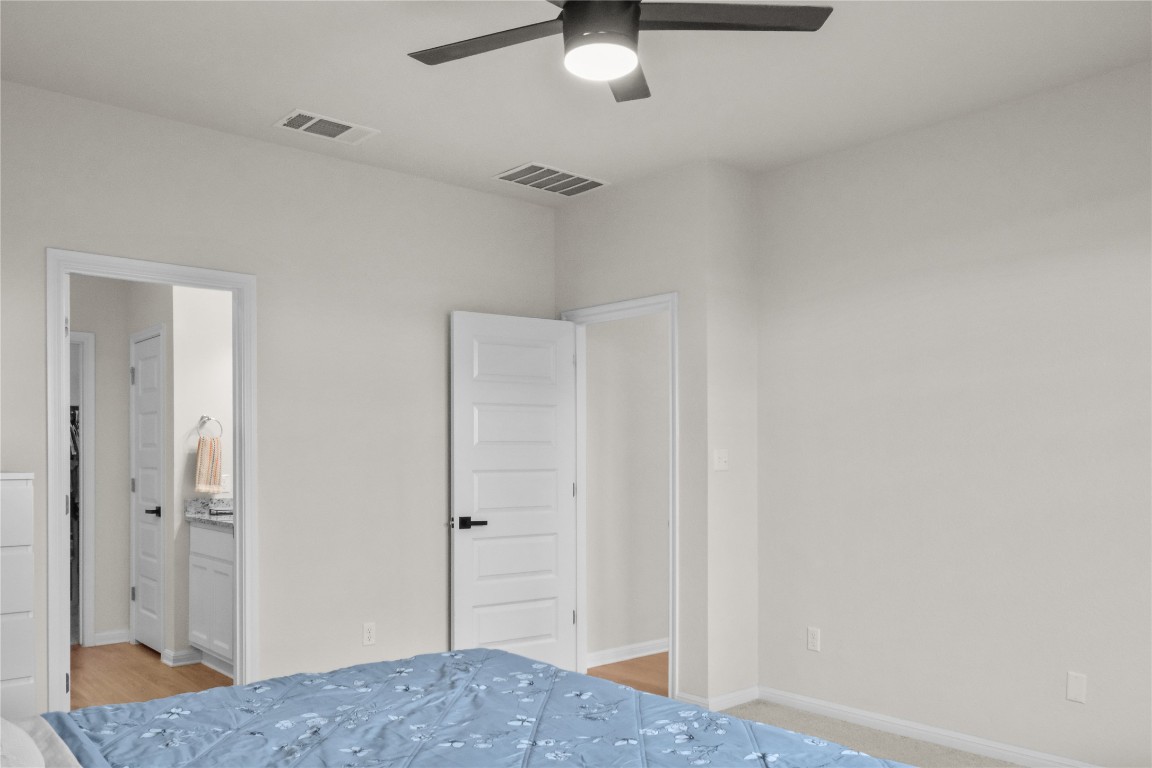 323 Tolo Drive Elgin, TX 78621 - Photo 14 of 32 Bedroom with a ceiling fan and ensuite bath