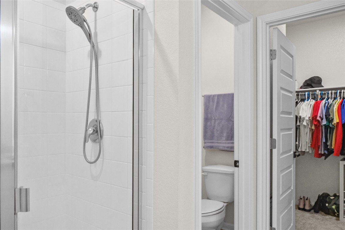 323 Tolo Drive Elgin, TX 78621 - Photo 16 of 32 Bathroom featuring a walk in closet and a shower stall