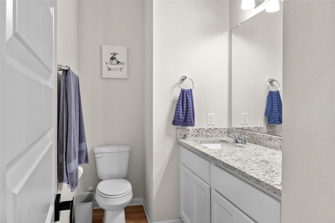 323 Tolo Drive Elgin, TX 78621 - Photo 23 of 32 Bathroom featuring vanity and dark wood-style flooring