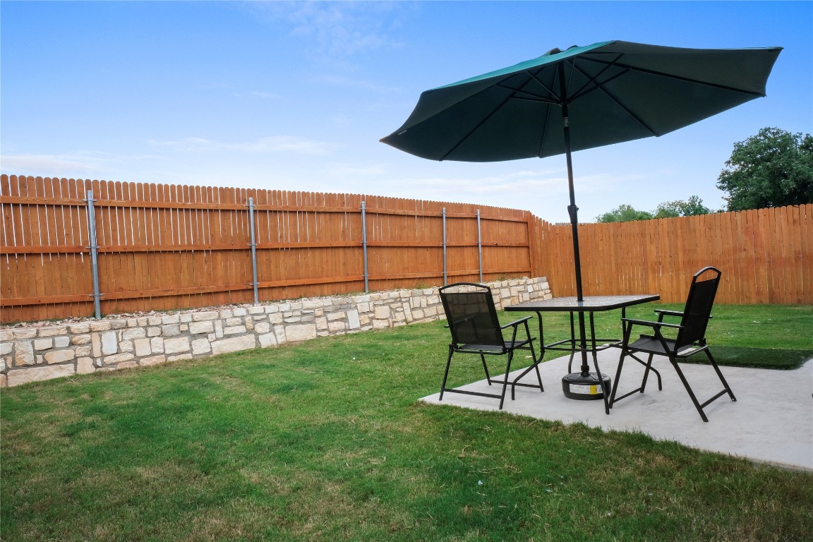 323 Tolo Drive Elgin, TX 78621 - Photo 27 of 32 Fenced backyard with a patio area