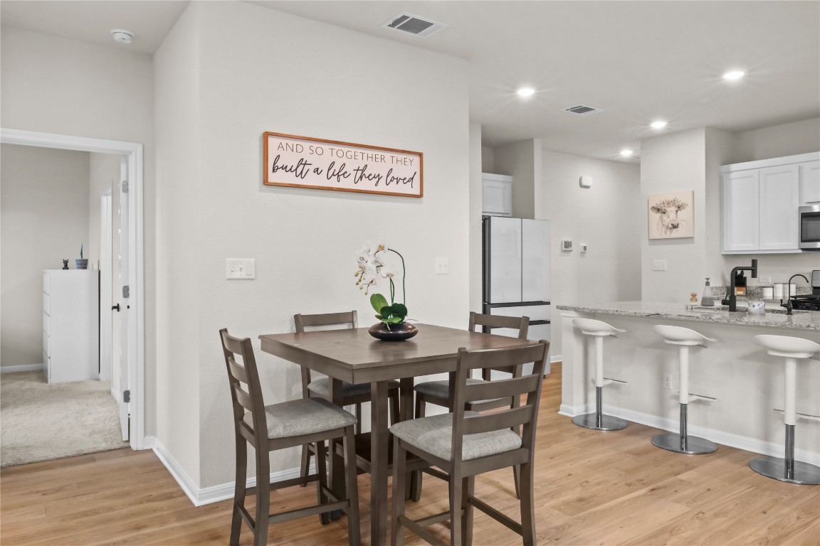 323 Tolo Drive Elgin, TX 78621 - Photo 7 of 32 Dining area featuring light wood-style flooring and recessed lighting